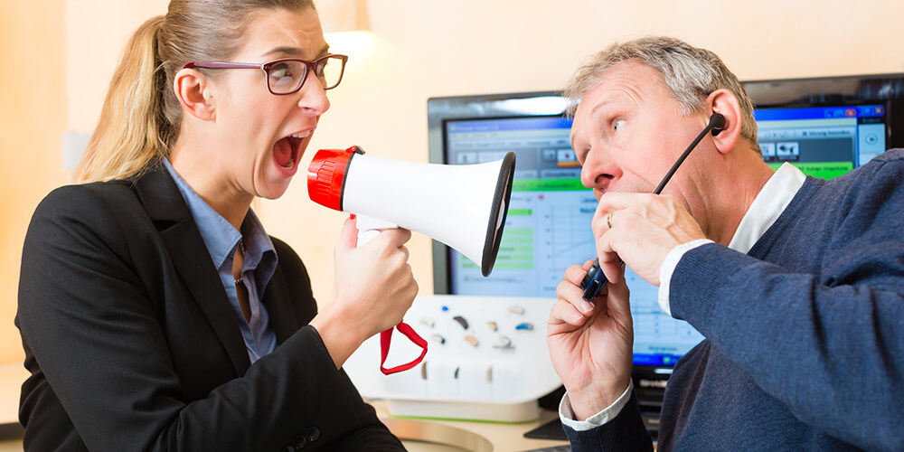 person with hearing loss in the workplace being shouted at